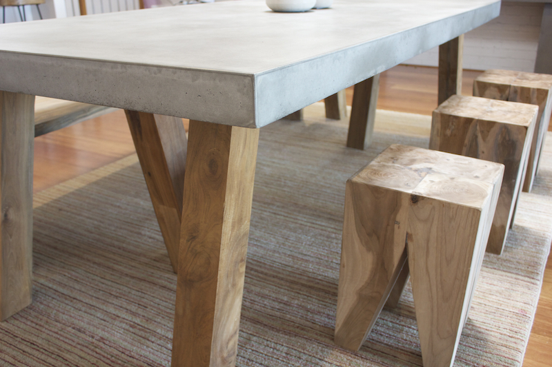 Stunning concrete and timber leg dining table by slabs by design