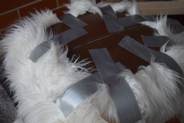 Duct tape fur fabric in place while the glue dries