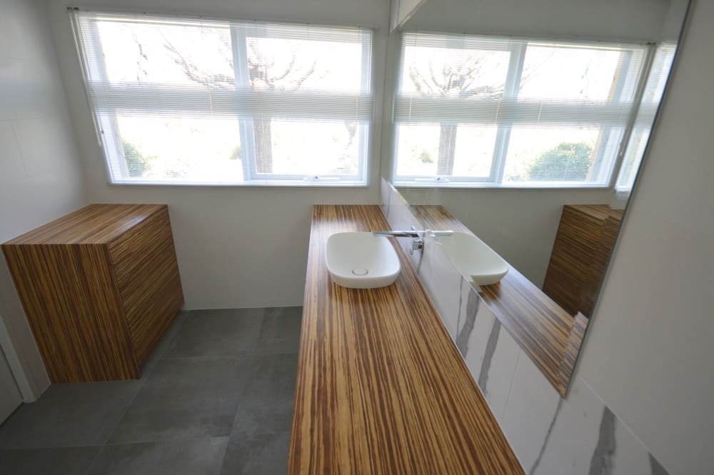 Bamboo vanity and storage in this modern marble makeover bathroom