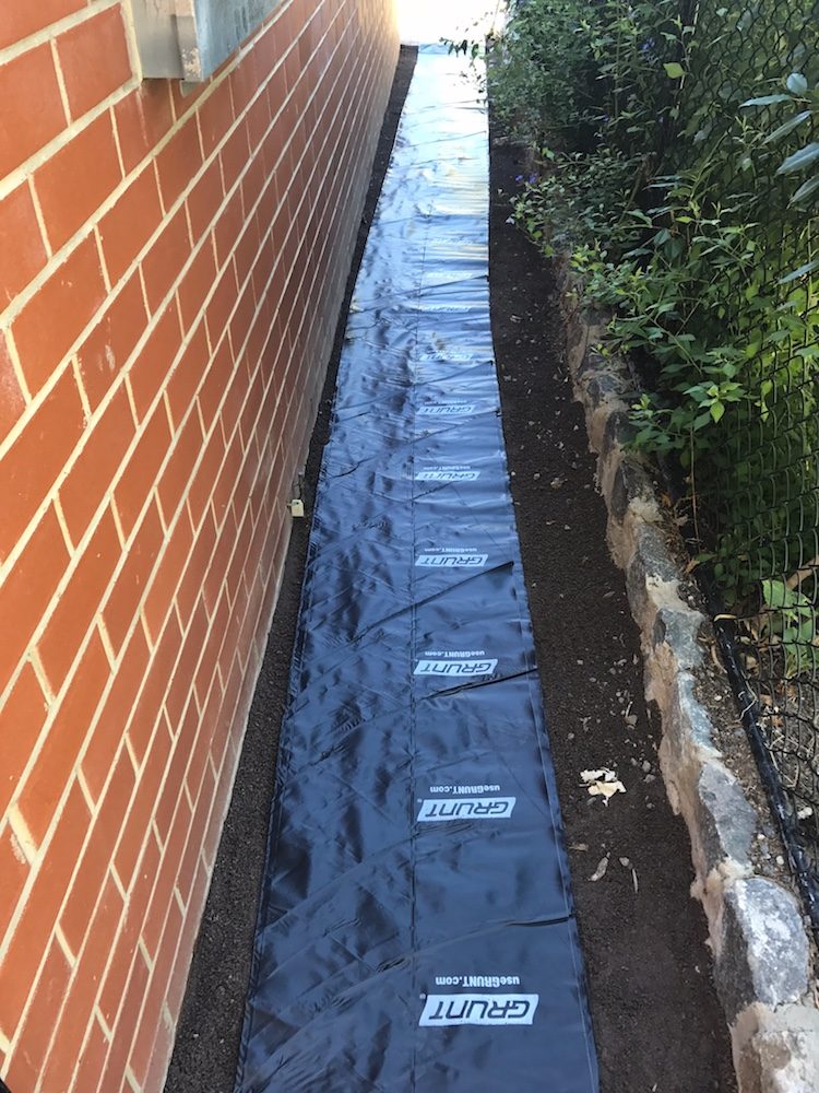 Putting down plastic to prevent weeds on useable path