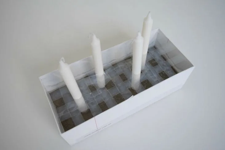 Allow concrete to set with candle in place