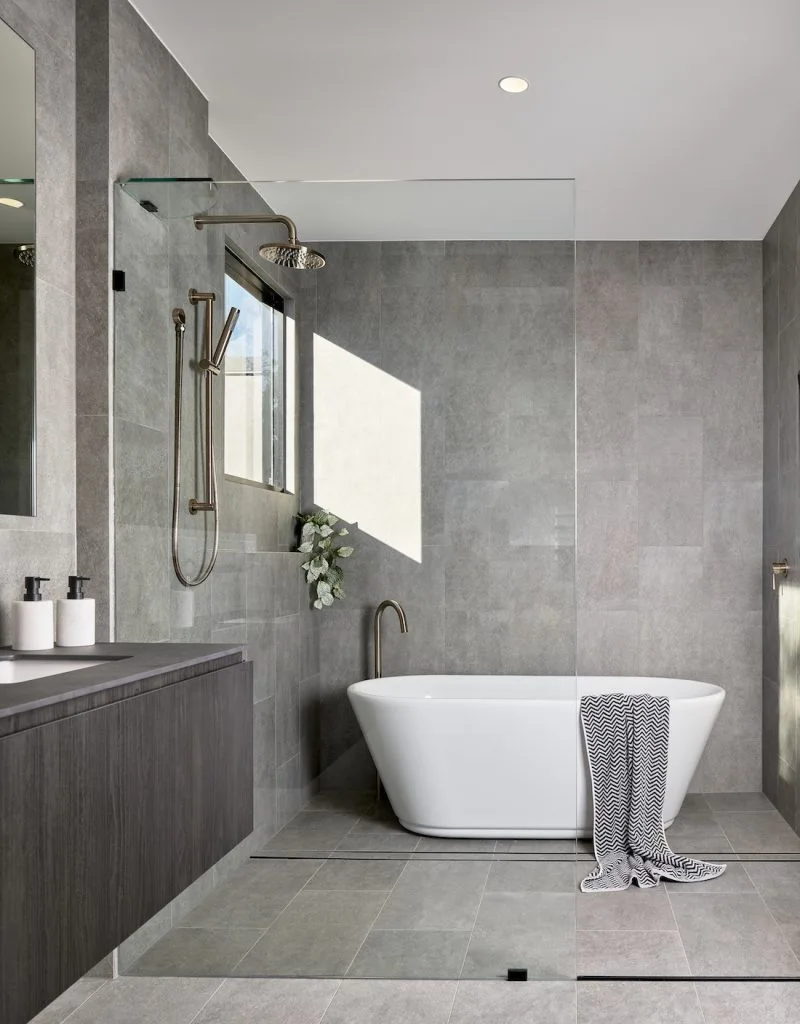 Main bathroom grey tiles floor to ceiling modern construction