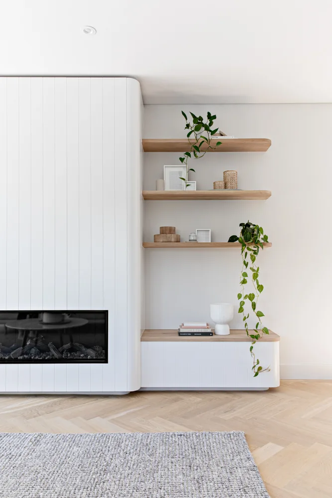 Curved edges by fireplace and custom shelving