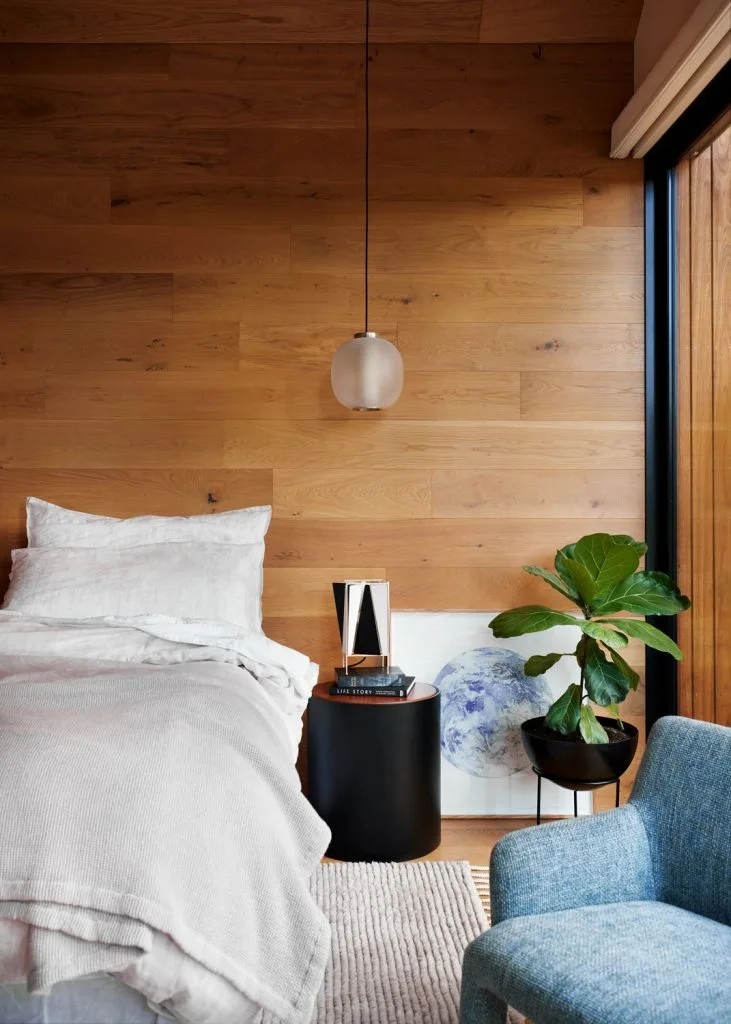 Simple styled bedroom with timber walls