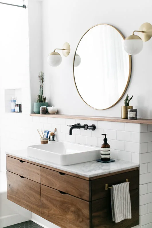 Gold round mirror in vintage bathroom