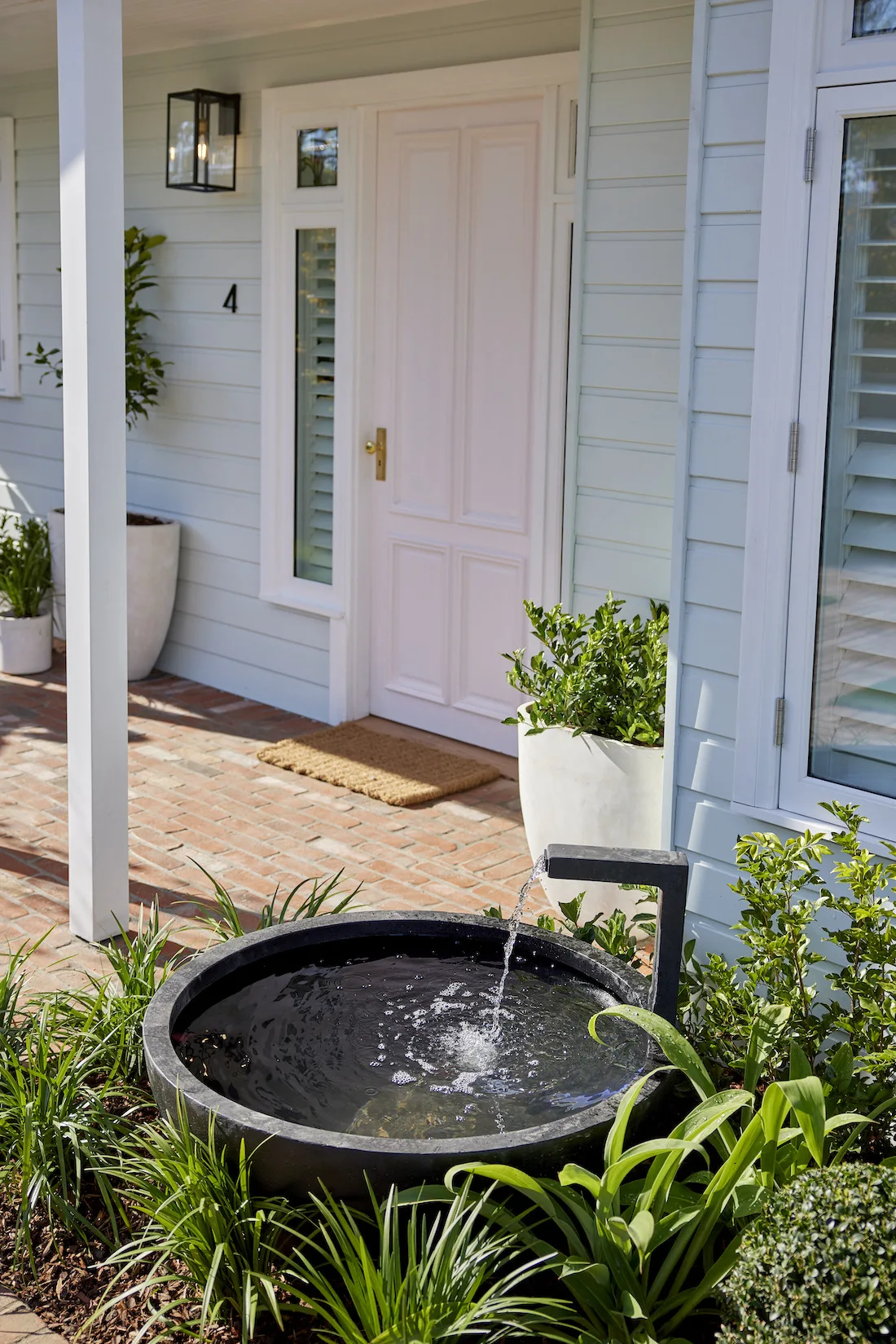 Water feature and pink front door