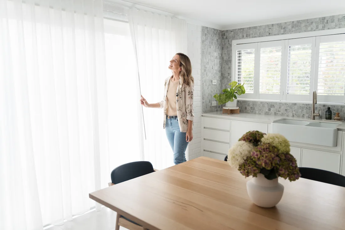 White wavefold curtains in kitchen complement the subtle Slim shaker cabinets