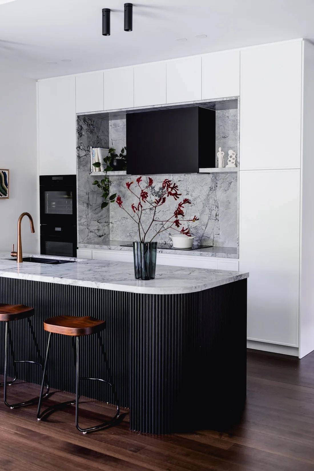 Black batten curved island bench in kitchen at Wattle Valley Road by Picchio Interiors