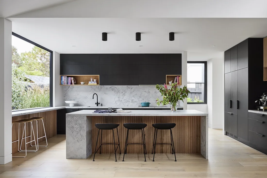 Timber and grey stone island bench in kitchen