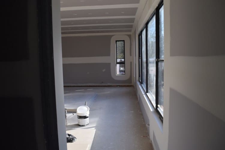 Looking from living area past pantry into kitchen and dining