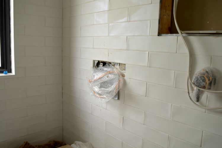 Removing tiles in the ensuite to fix the leak