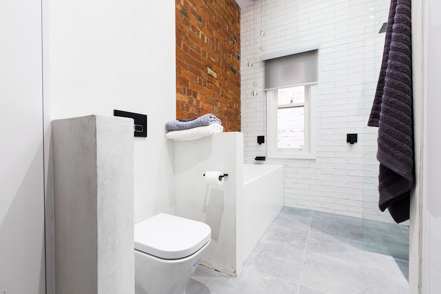 Bathroom with exposed brick