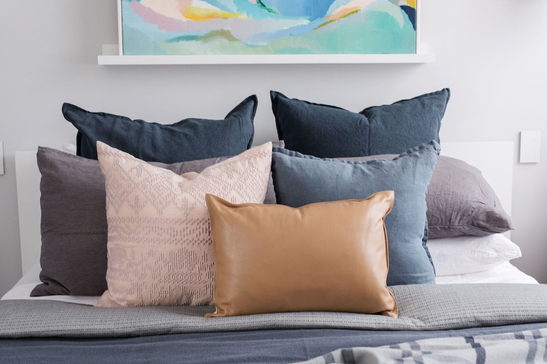 Arranging cushions on bed