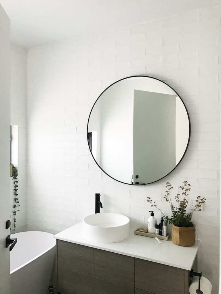 Round mirror in bathroom