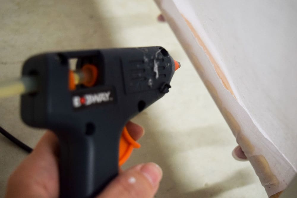 Glue fabric along dowel to create a DIY play tent