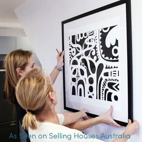 Shaynna Blaze hanging art on Selling Houses Australia