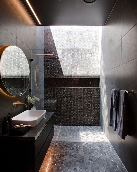 Black bathroom with metallic accents