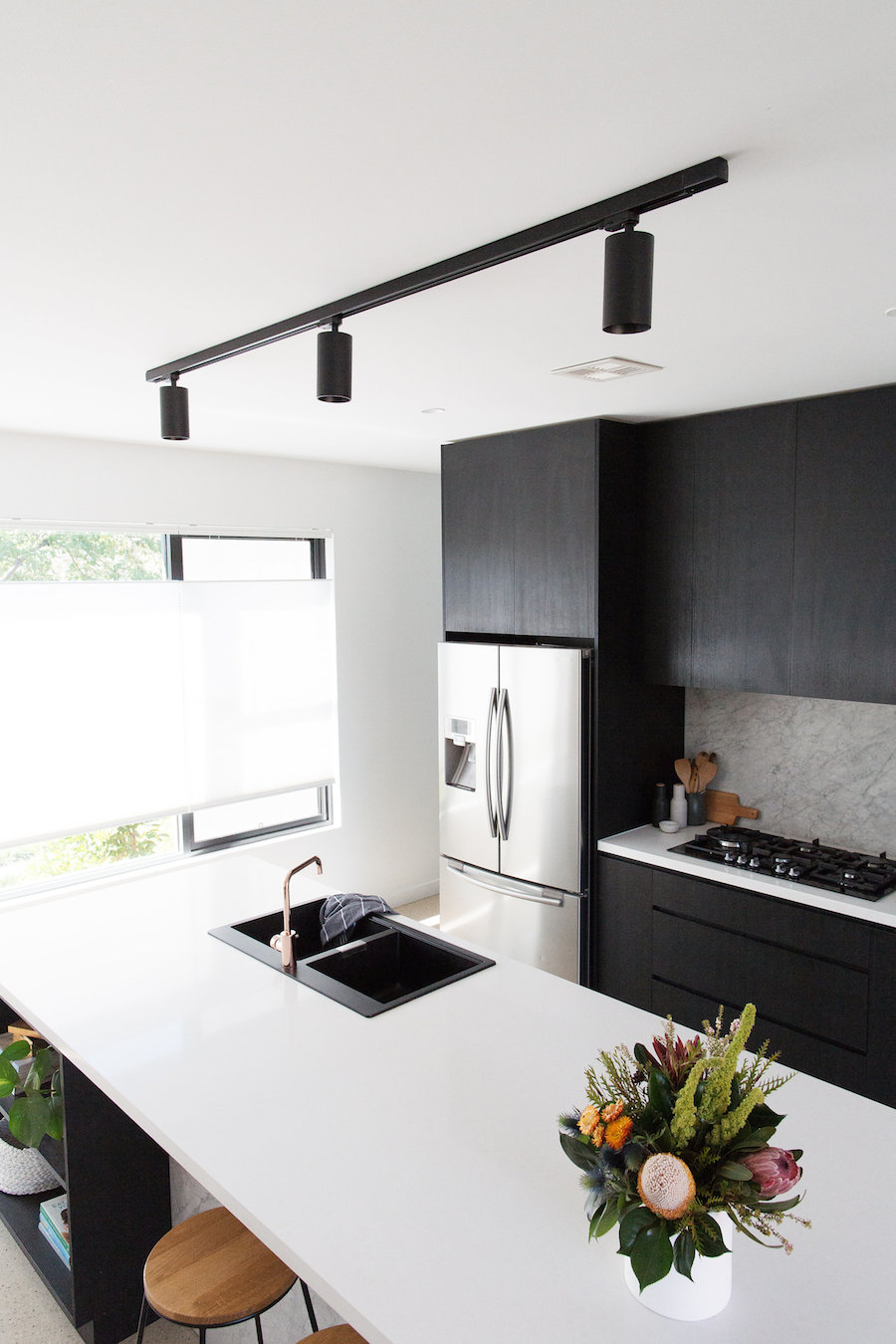 Black track ceiling mount light in the kitchen
