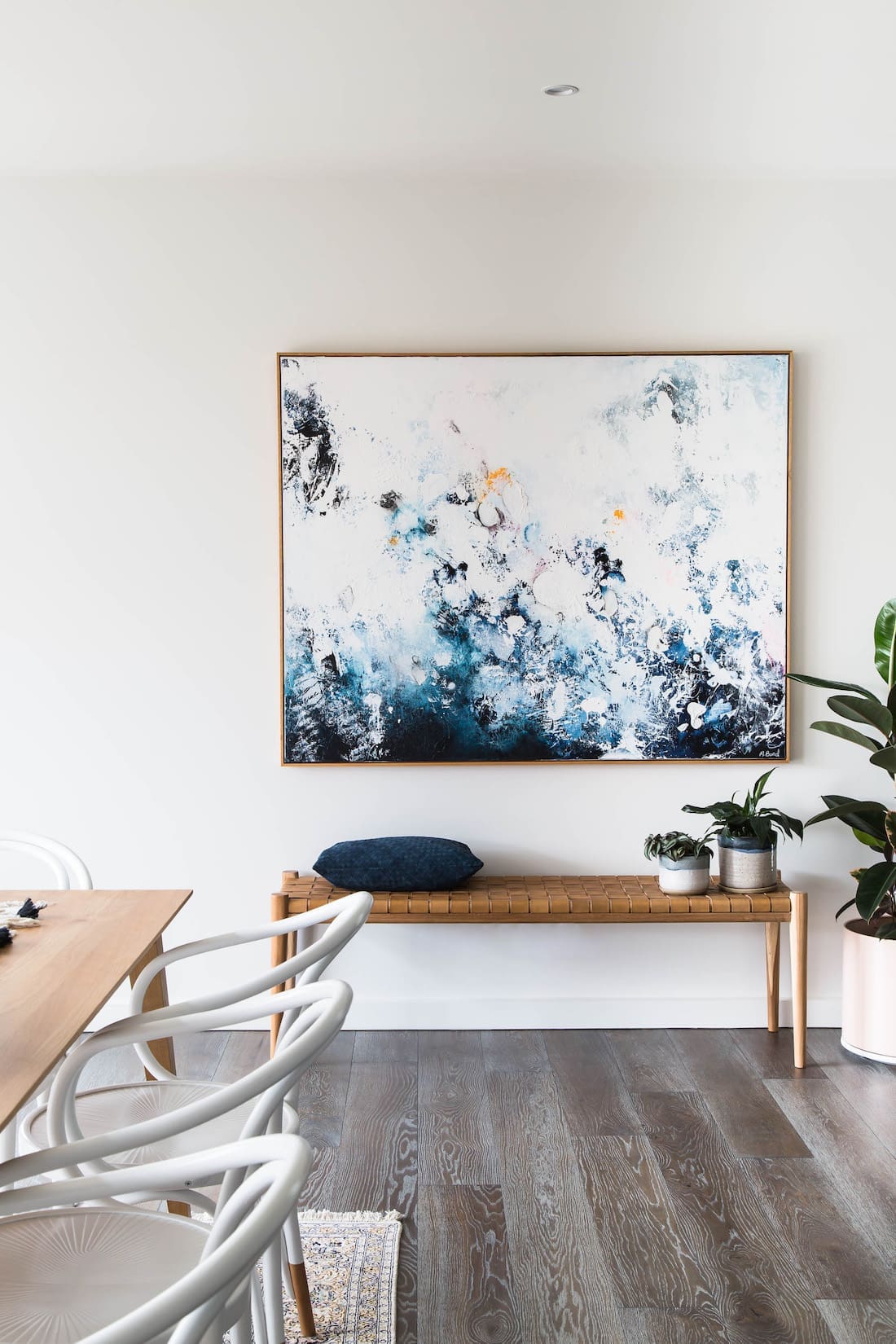 Bench seat underneath artwork at bayside home