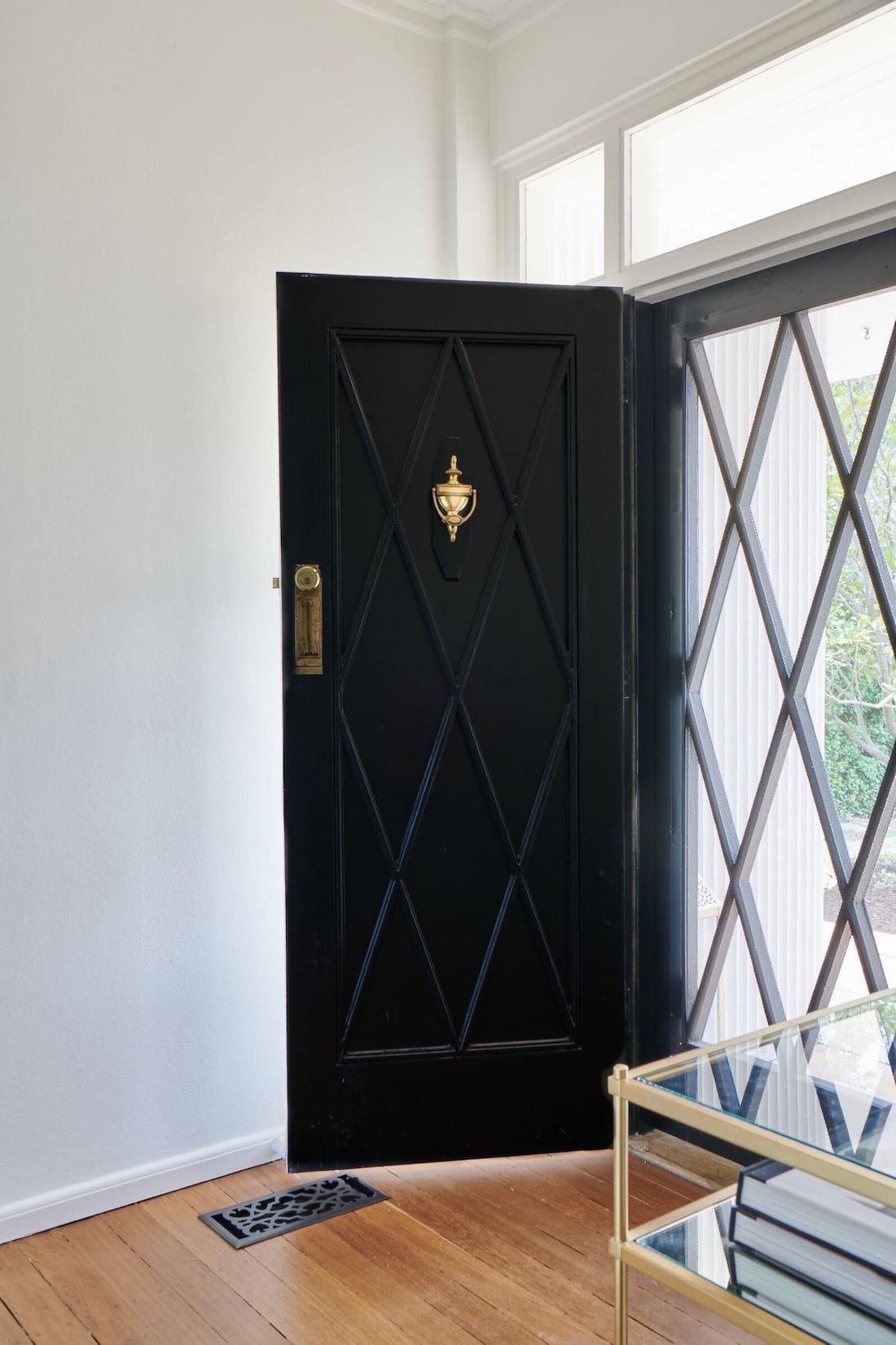 Black front door and original Tallowwood flooring in Wisteria House