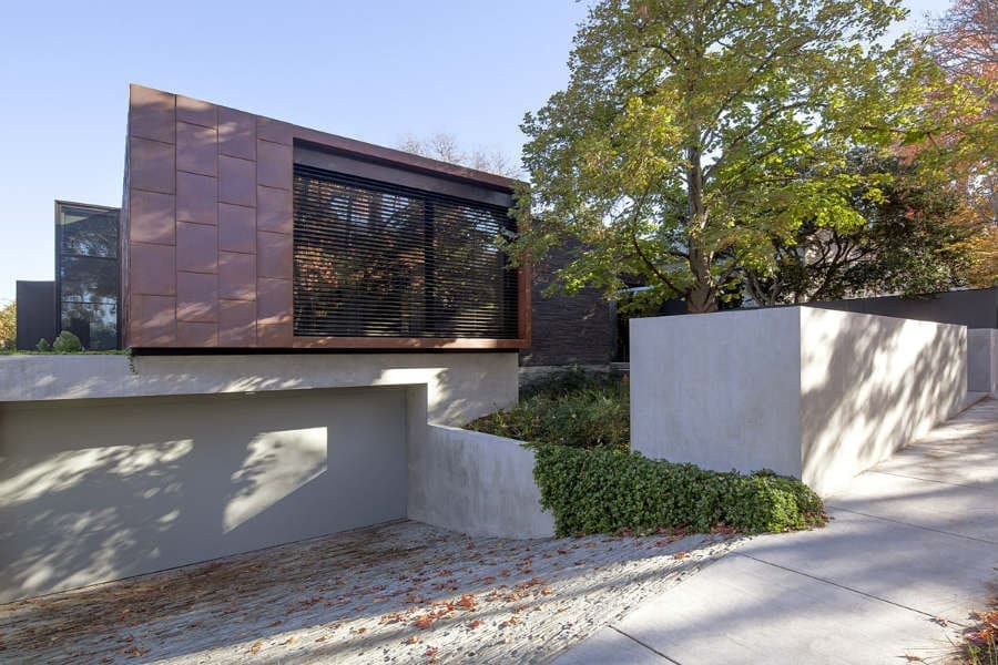 Rock driveway on metal clad house