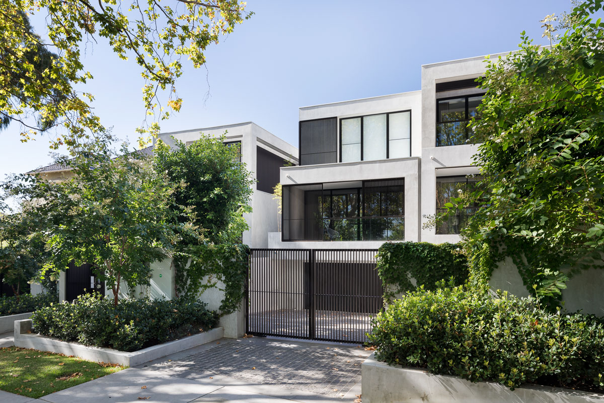 Cobblestone drive with modern black metal gate