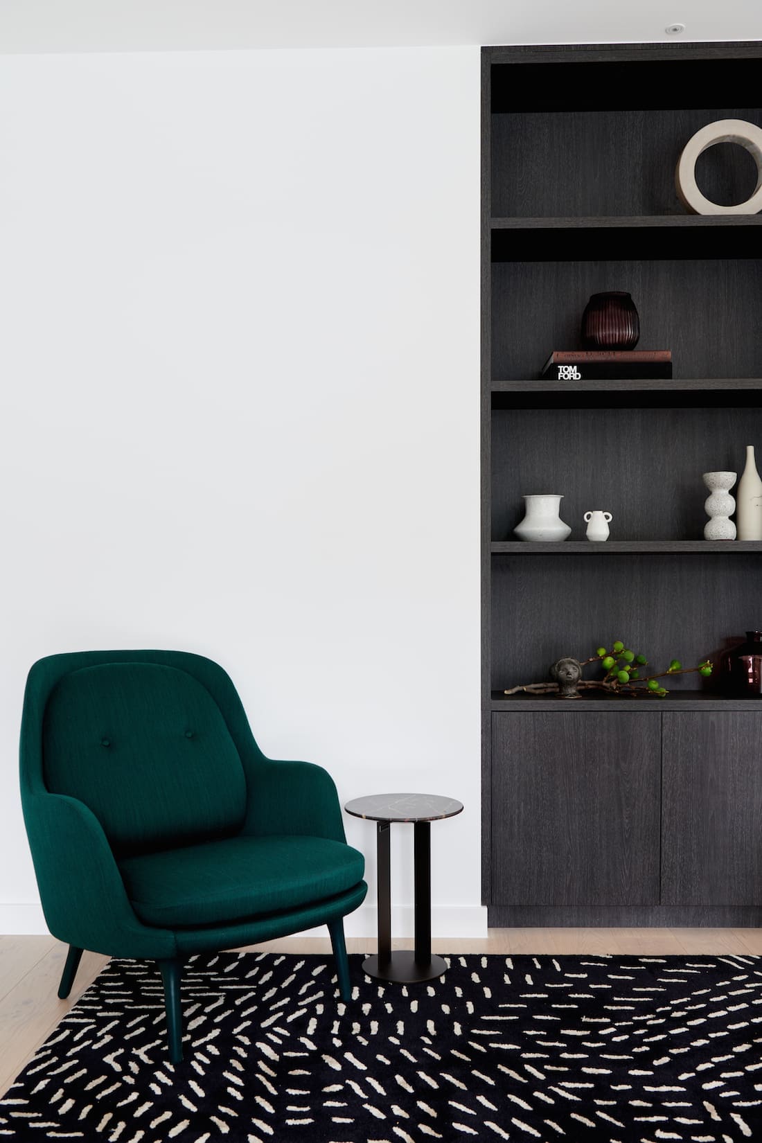 Alexi George styling lounge room with green velvet chair and bookcase in this modern home joinery perfection