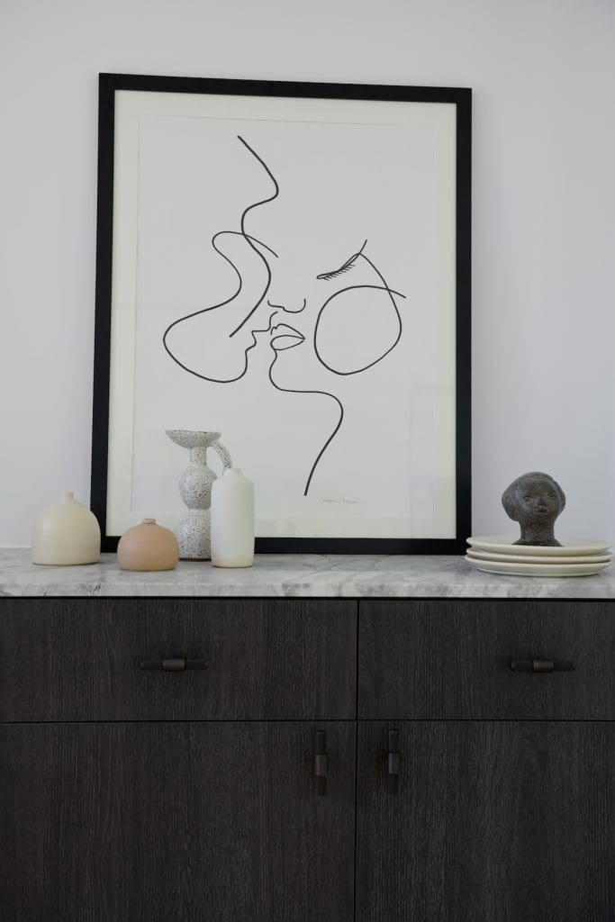 Artwork and ceramics styling on sideboard