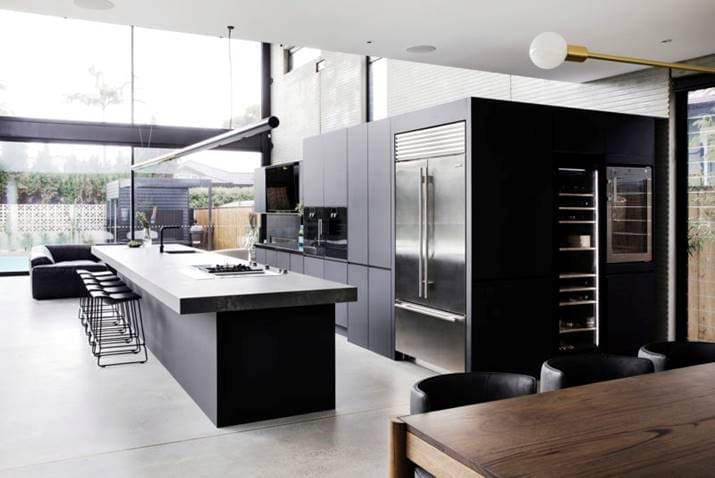 Black kitchen with full sized wine fridge