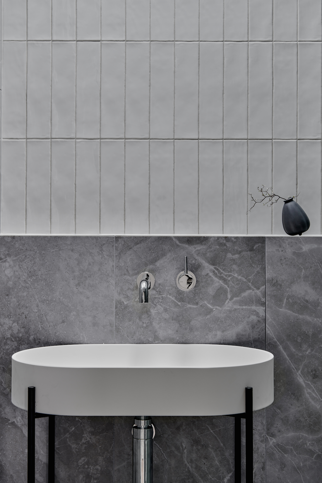 Close up of sink and half height wall tiles