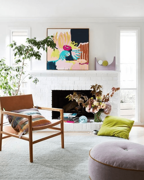 Bright and colourful living room styling on a fireplace mantel