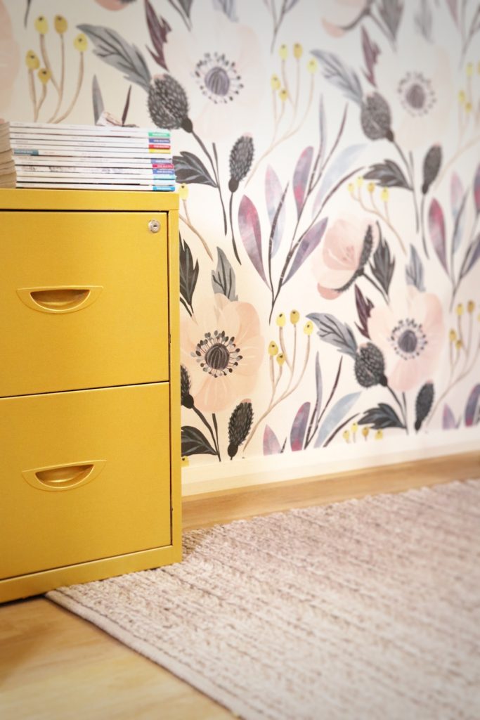 Yellow filing cabinet in wallpapered office