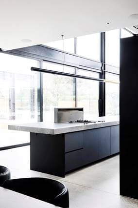 Floor to ceiling windows in black kitchen