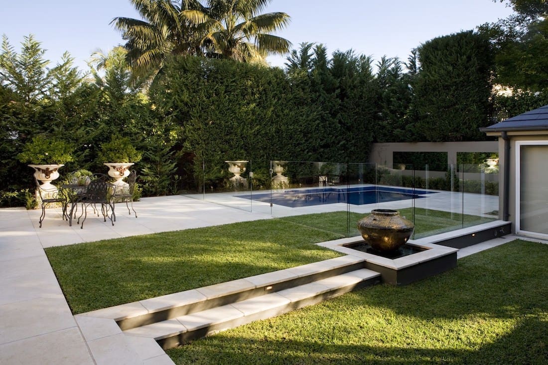 Outdoor garden pool area with grass and paving