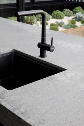 Black sink and tap in stone bench Guy Sebastian kitchen