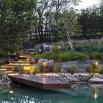 Tiered garden with wooden pontoon and lighting