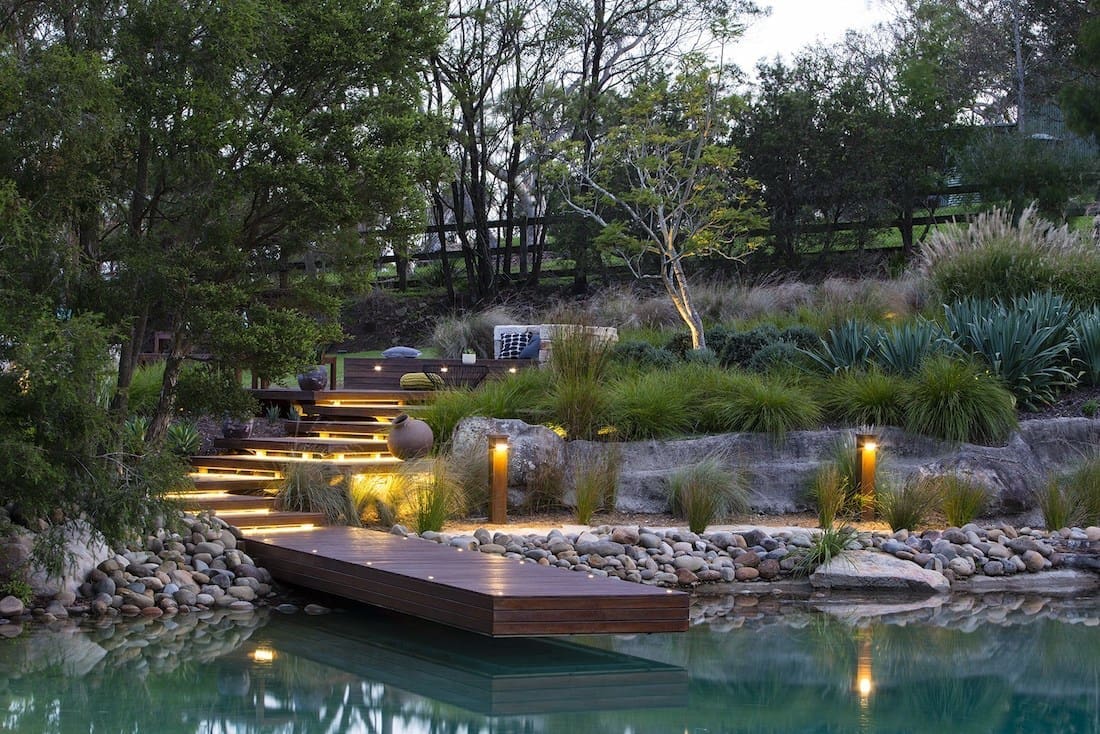 Tiered garden with wooden pontoon and lighting