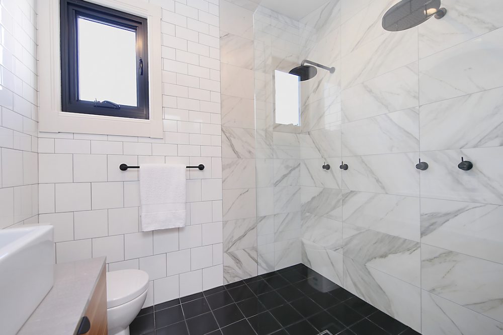 White modern bathroom with marble tiles