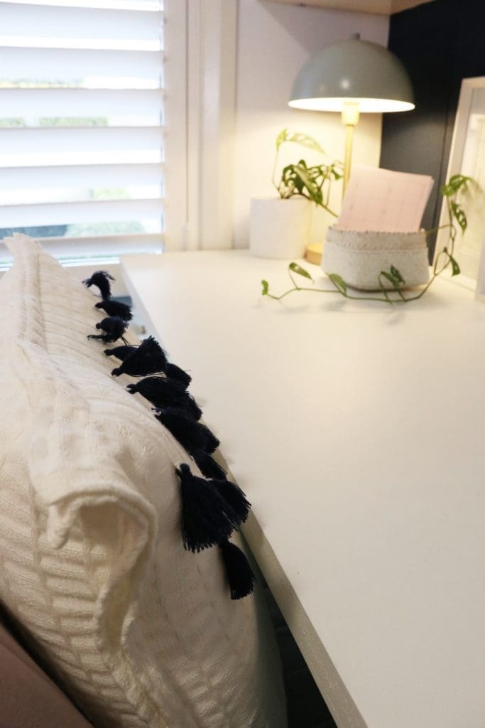 White desk with lamp and cosy cushion