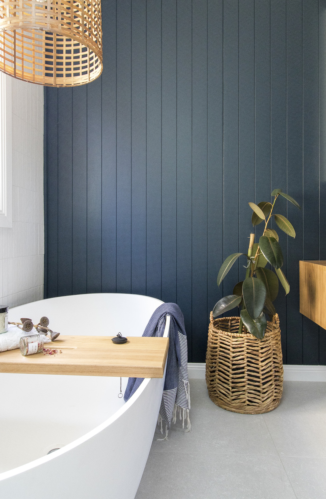 Blue panelling bathroom wall with freestanding bath