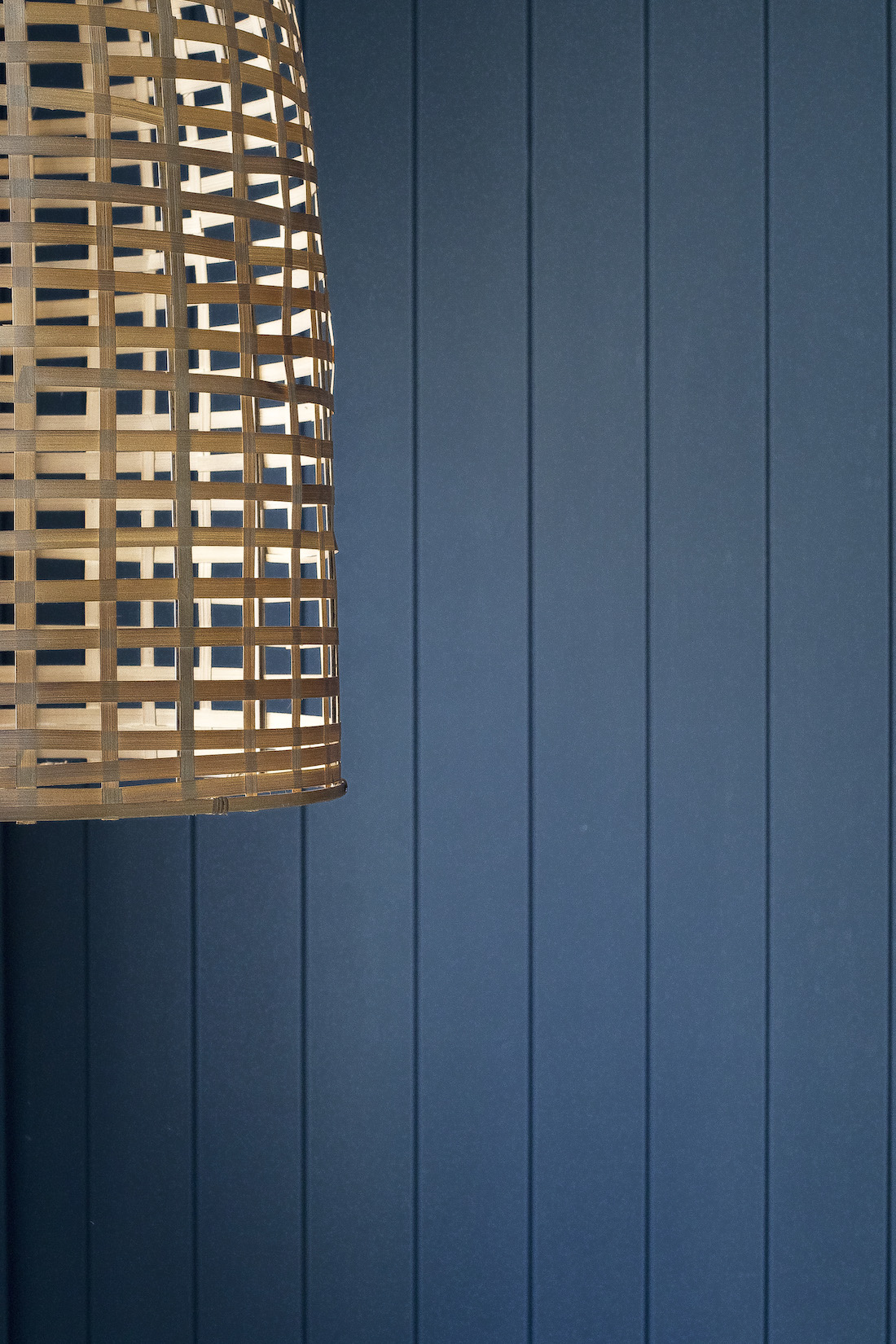 Blue panelling wall with basket light