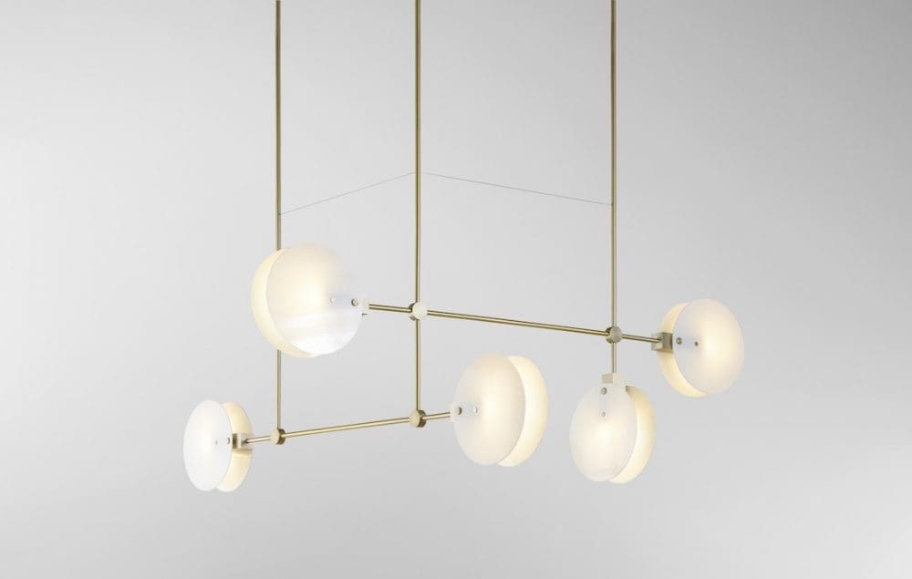 Brass and white chandelier lighting by Ross Gardam