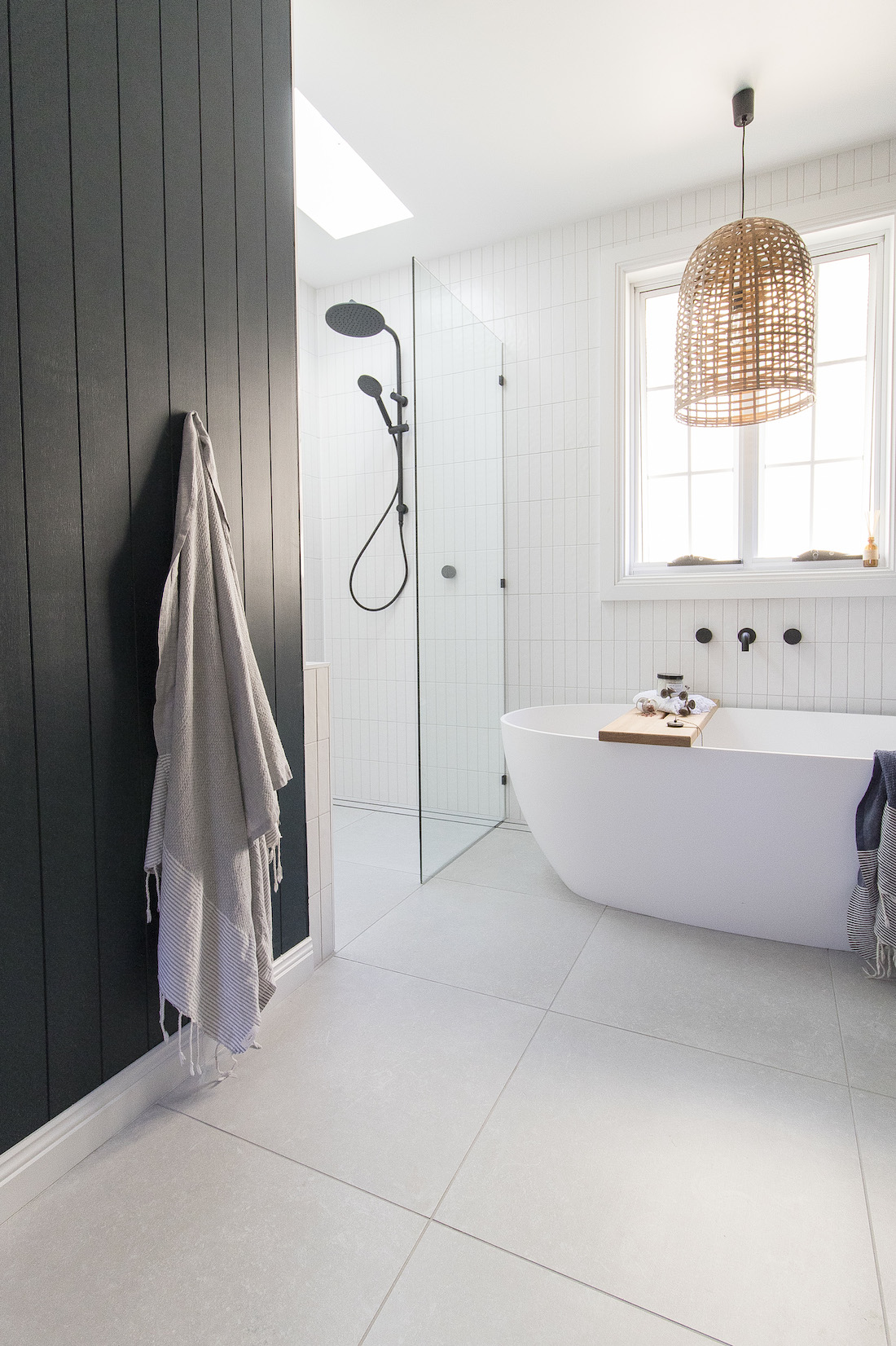 White bathroom with dark wall panelling in coastal luxe bathroom