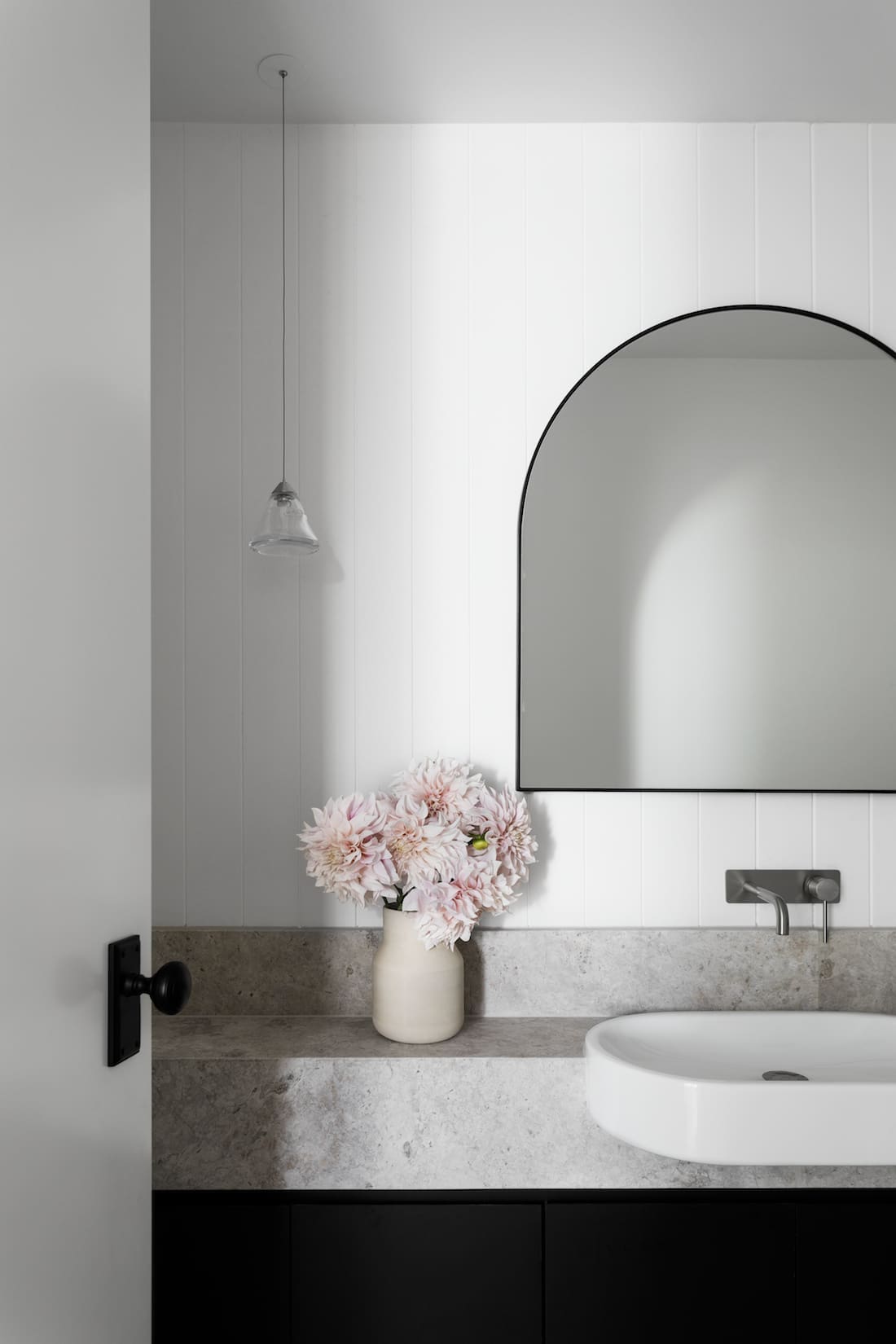 Bask Interiors stone benchtop with arch mirror bathroom