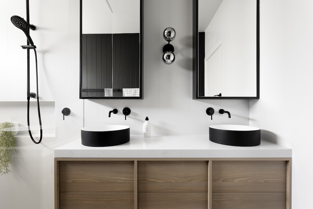 Black feature bathroom with double vanity by GIA Bathrooms & Kitchens