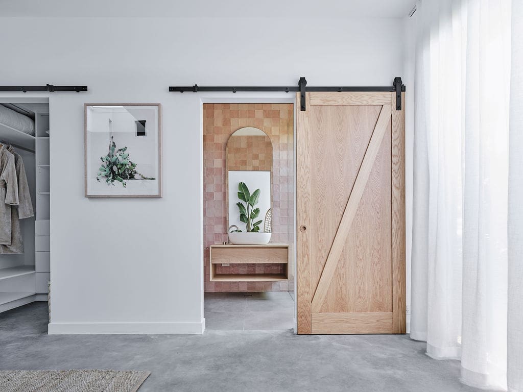 Barn door to pink bathroom