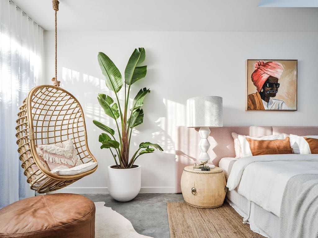 Hanging swing chair in pink neutral bedroom