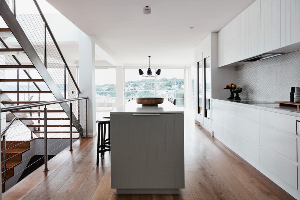 Kitchen with a view and open staircase by Oliver Myles