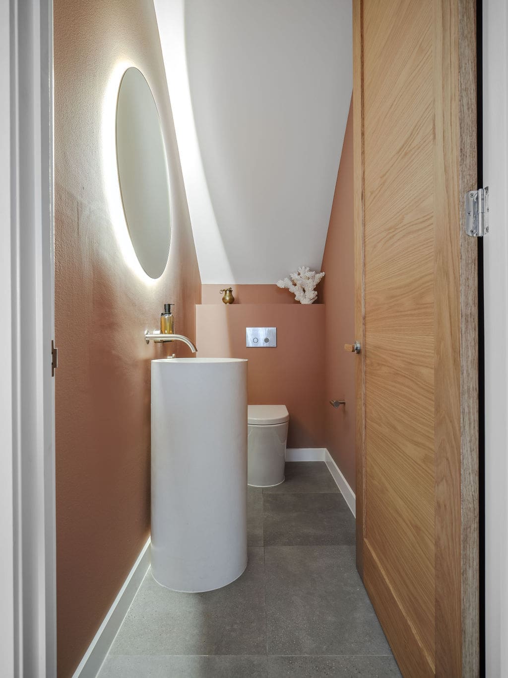 Pink and white bathroom with standing vanity