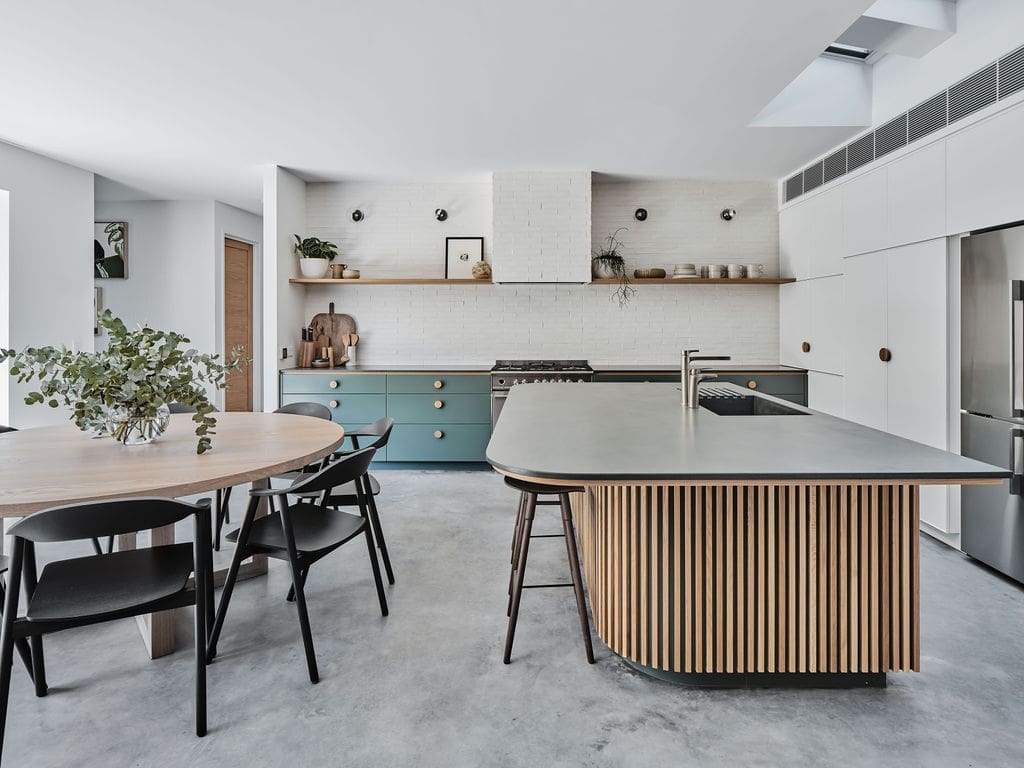 White and teal kitchen with wood panel highlights